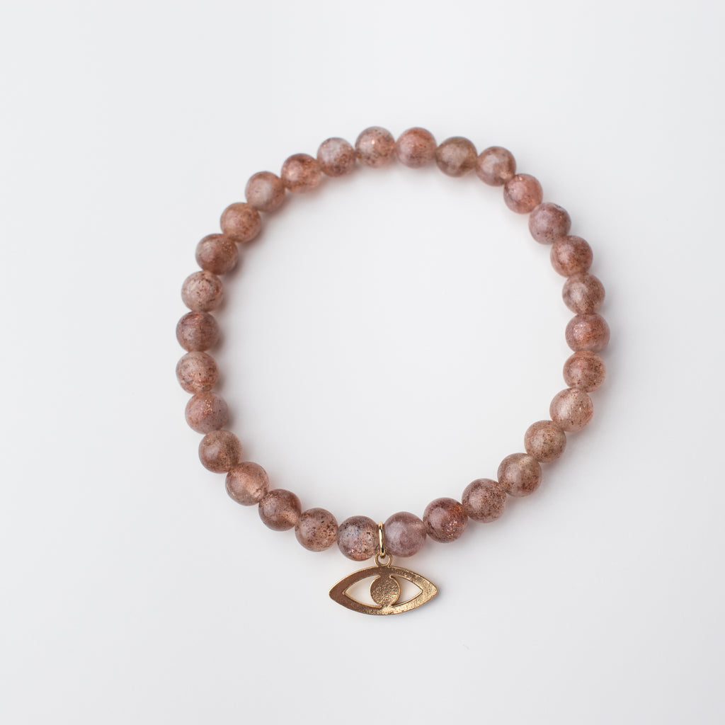 Blush Muscovite bead stretch bracelet with gold eye charm