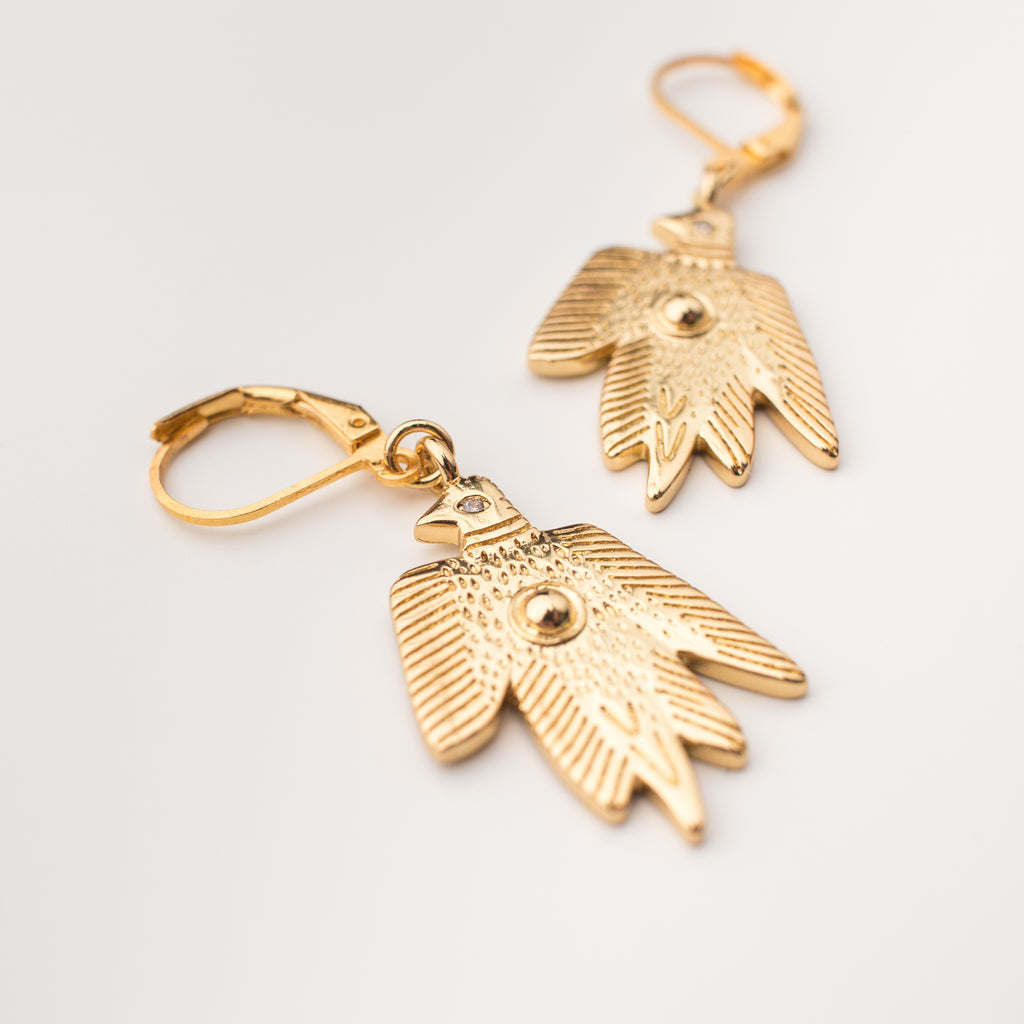 Gold birds with a zircon eye earrings in a matching style.