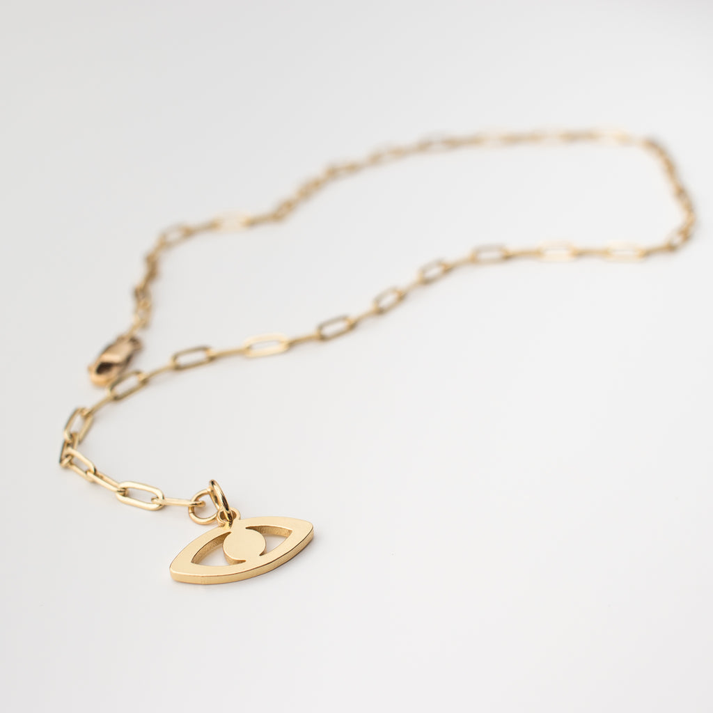 Gold paperclip chain anklet with gold eye charm. 