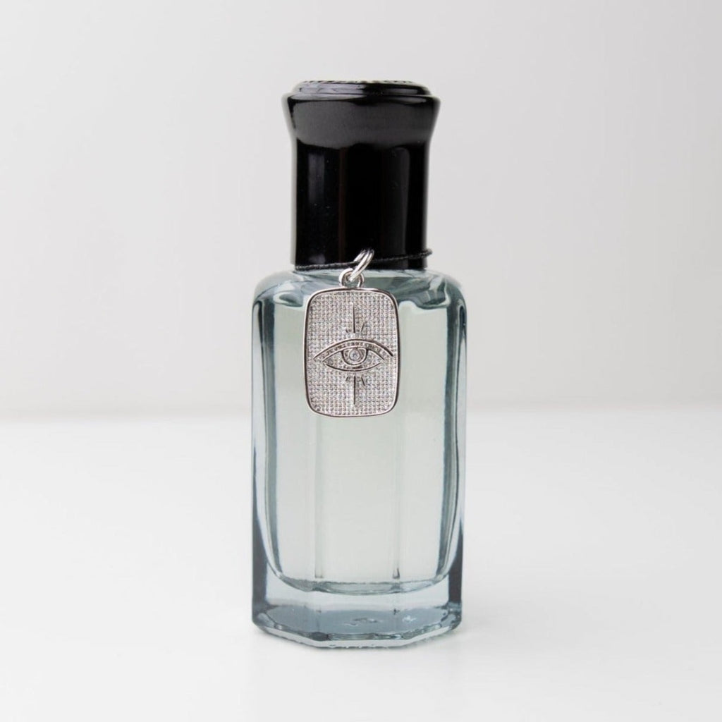 Talismanic 01. Bourbon, vanilla, tobacco, sandalwood and clover cologne, fragrance for men, unisex scent, natural fragrance with a silver eye charm for inner wisdom. Glass bottle with a roller ball dispenser. self care