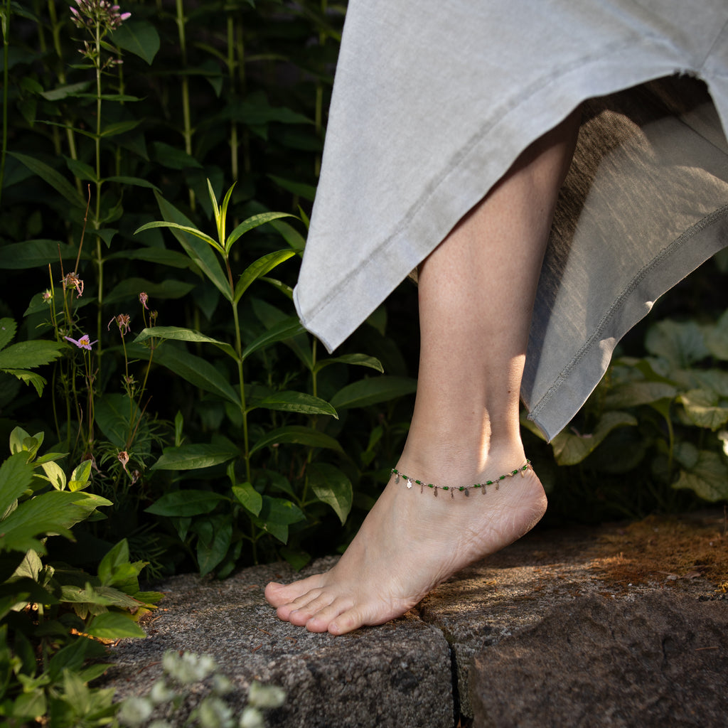 Model is wearing a dainty green and silver anklet from up-cycled chain, limited edition. 