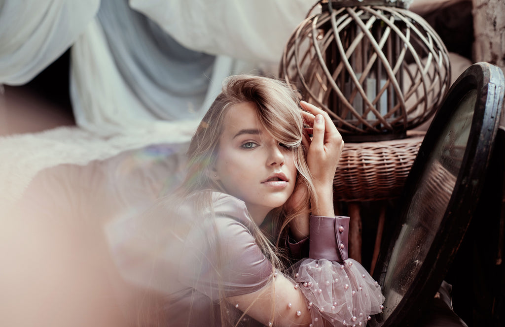 Image of a girl in a boho styled room. Embracing the high bohemian aesthetic of unconventional artists through history. 