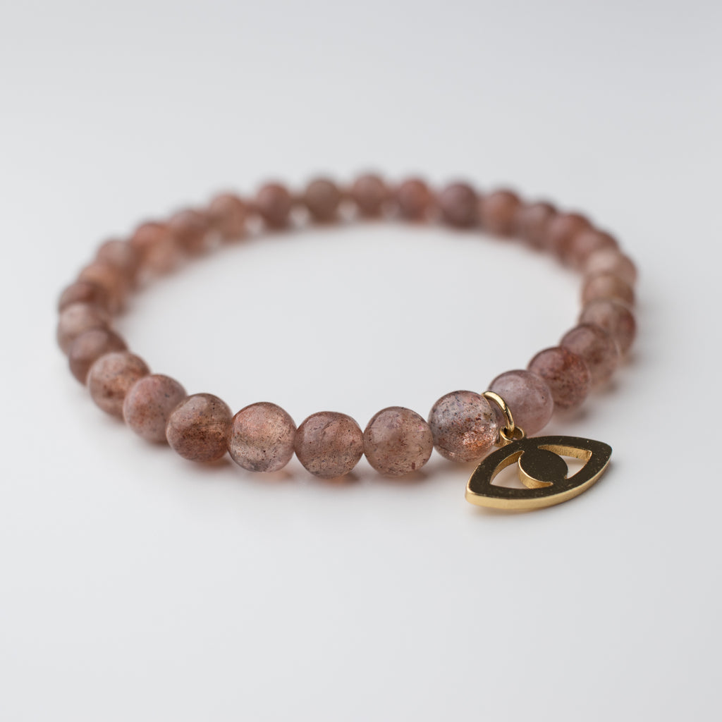 Blush Muscovite bead stretch bracelet with gold eye charm