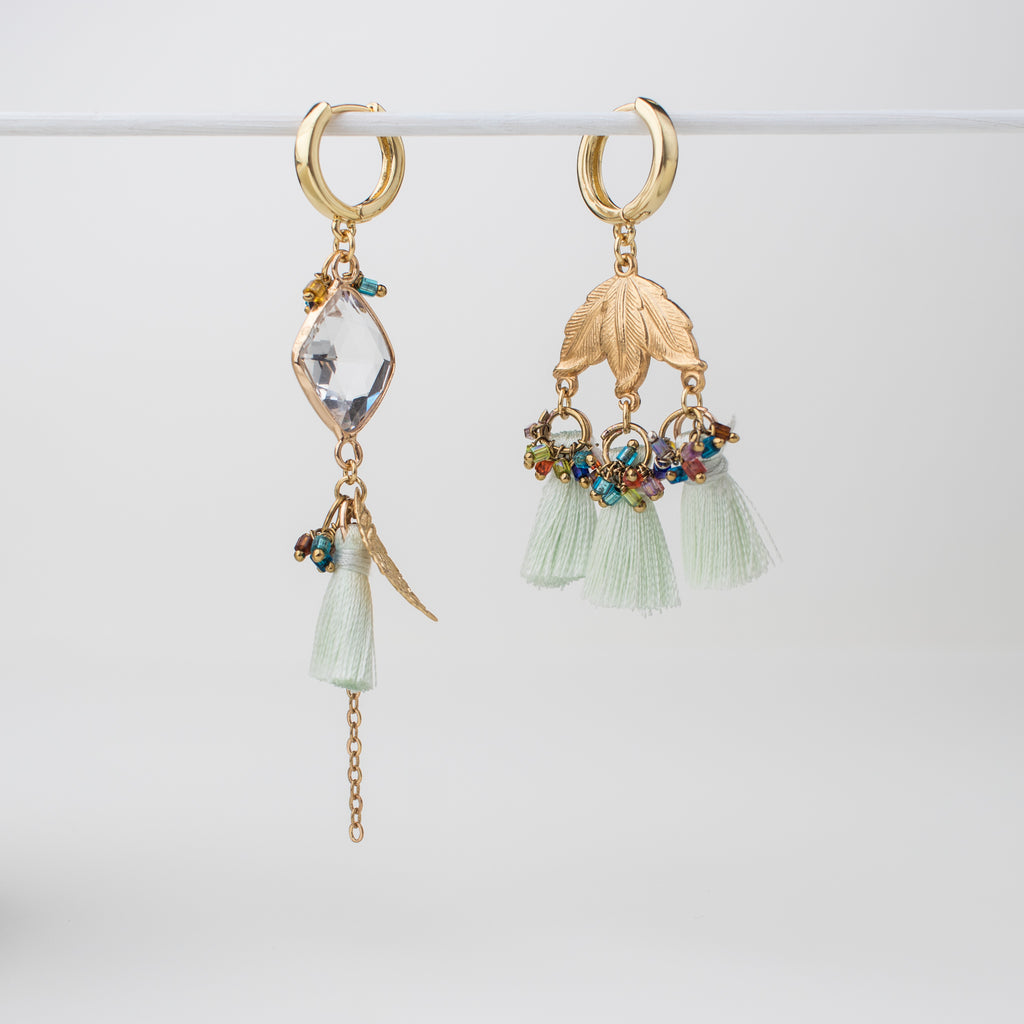 Gold green tassel hoop earring with gold leaves and upcycled components in a mismatch style.
