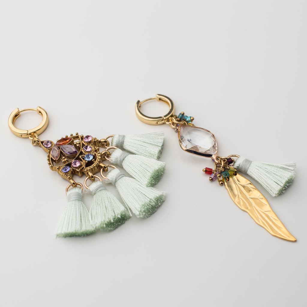 Gold green tassel hoop earring with gold feather and upcycled components in a mismatch style.