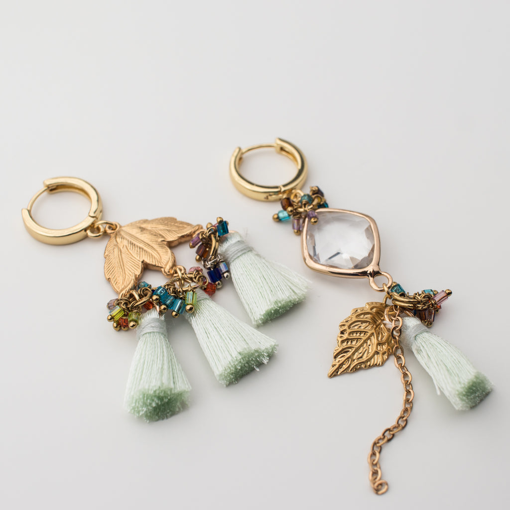 Gold green tassel hoop earring with gold leaves and upcycled components in a mismatch style.