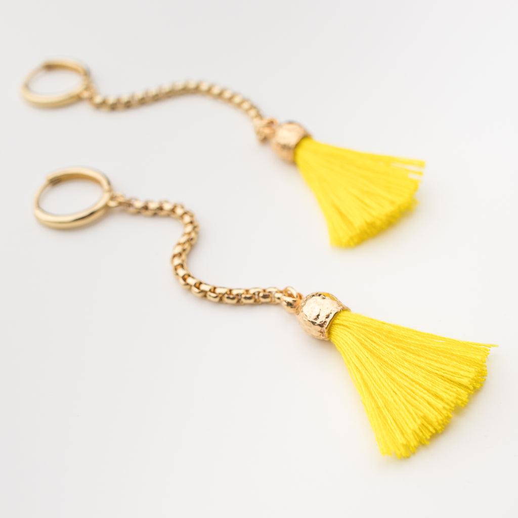 Bright yellow tassel with a gold chain on a mini hoop, matching style earrings. 