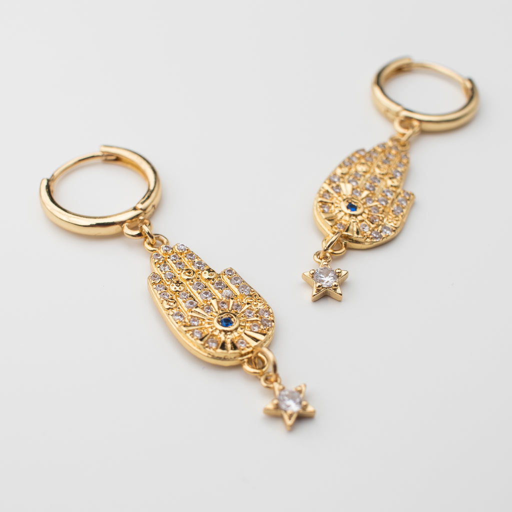 Gold filled hamsa hand and star earring with a dark blue zirconia eye. Matching or single.