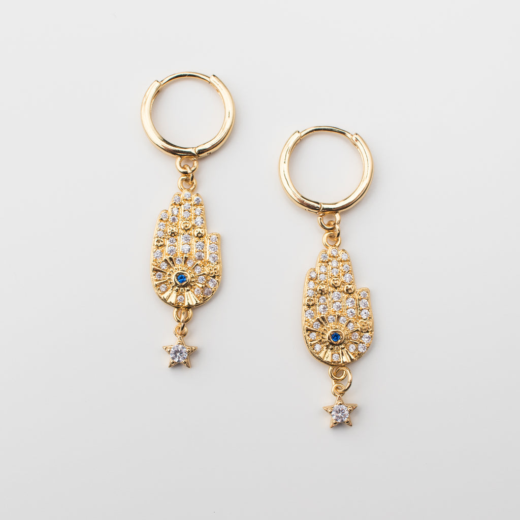Gold filled hamsa hand and star earring with a dark blue zirconia eye. Matching or single.
