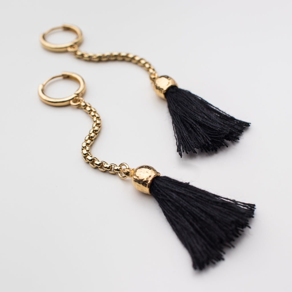 Black tassel with a gold chain on a mini hoop, matching style earrings. 