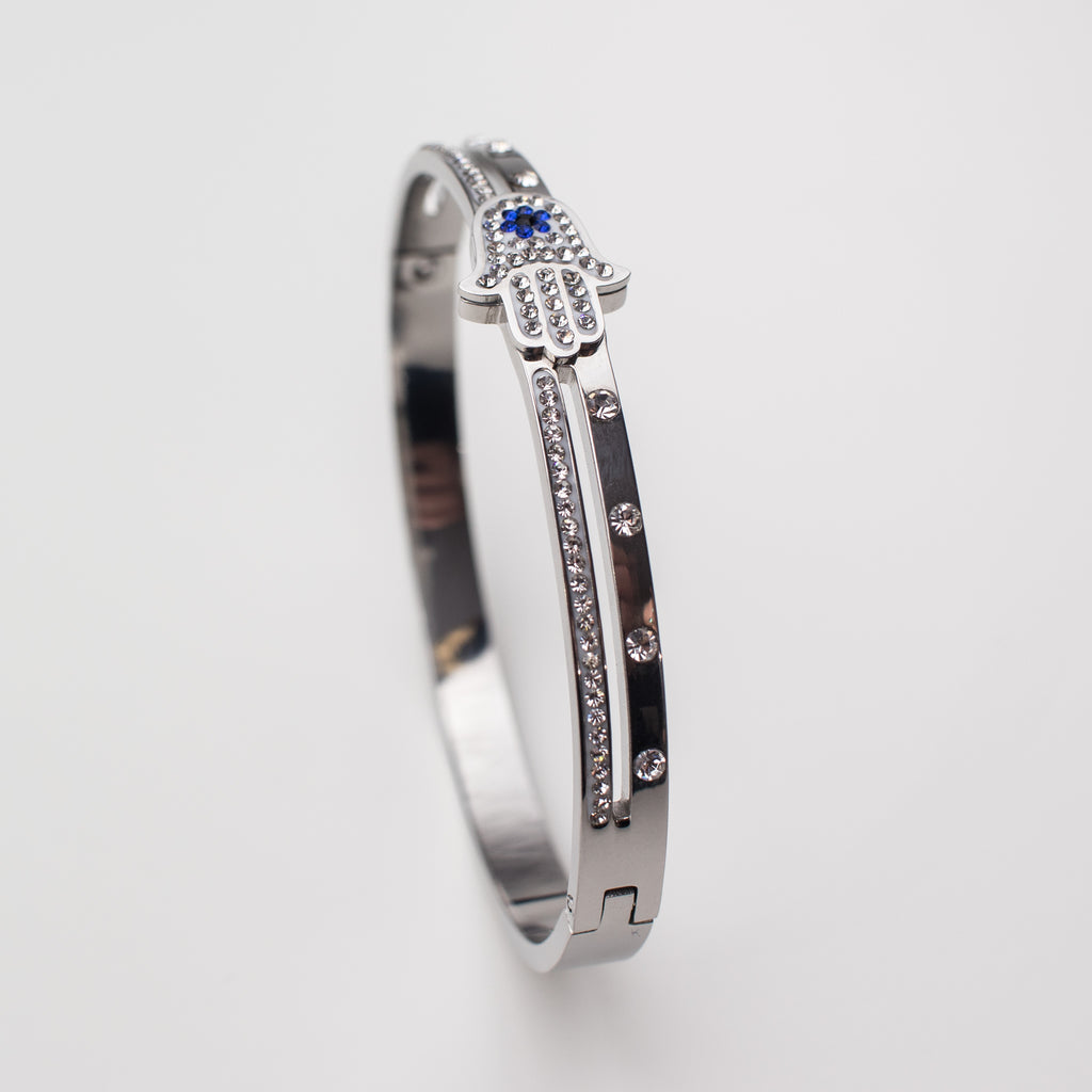 Stainless steel bracelet with hamsa hand and cubic zirconia, bangle style.