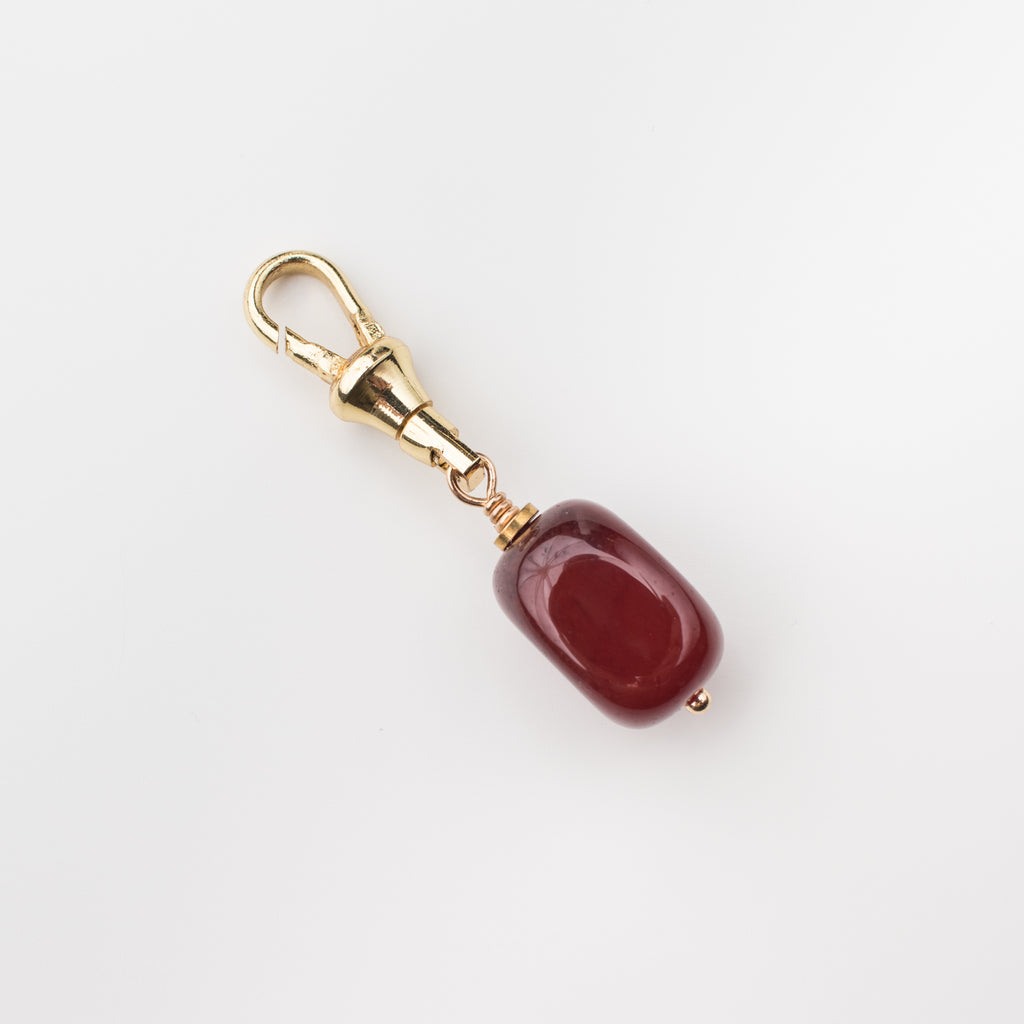 Orangey red carnelian gemstone charm on a gold latch for a dog leash, dog collar, handbag, change purse, on the go lululemon bag and key chain. 