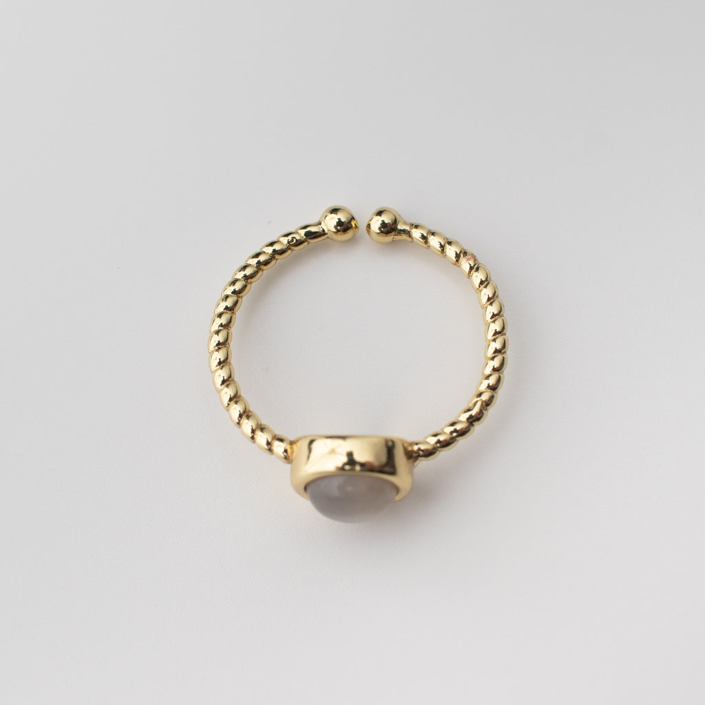 Gold twisted adjustable ring with a milky grey gemstone agate centre. 