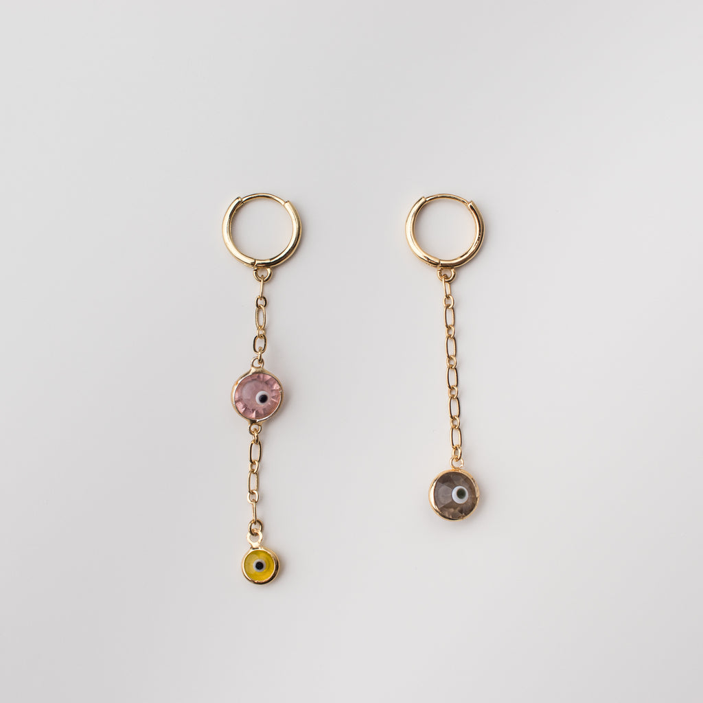 Gold mini hoop earrings with light pink, taupe & yellow crystal eye charms.