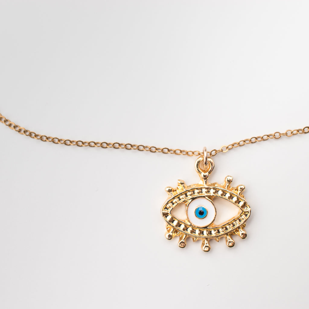Gilded golden eye pendant with a white & blue enamel eye centre on a gold filled chain. 